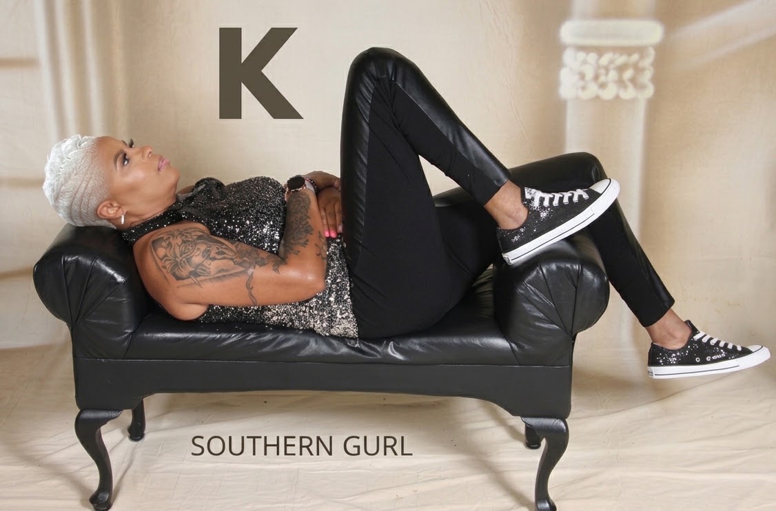 DJ Kelly Kel reclining on a black chaise, from the Southern Gurl photograph